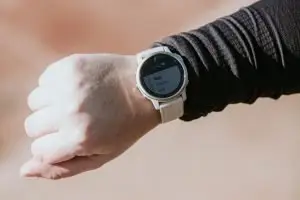 A closeup image of a Garmin watch to be used for heart rate training for a runner