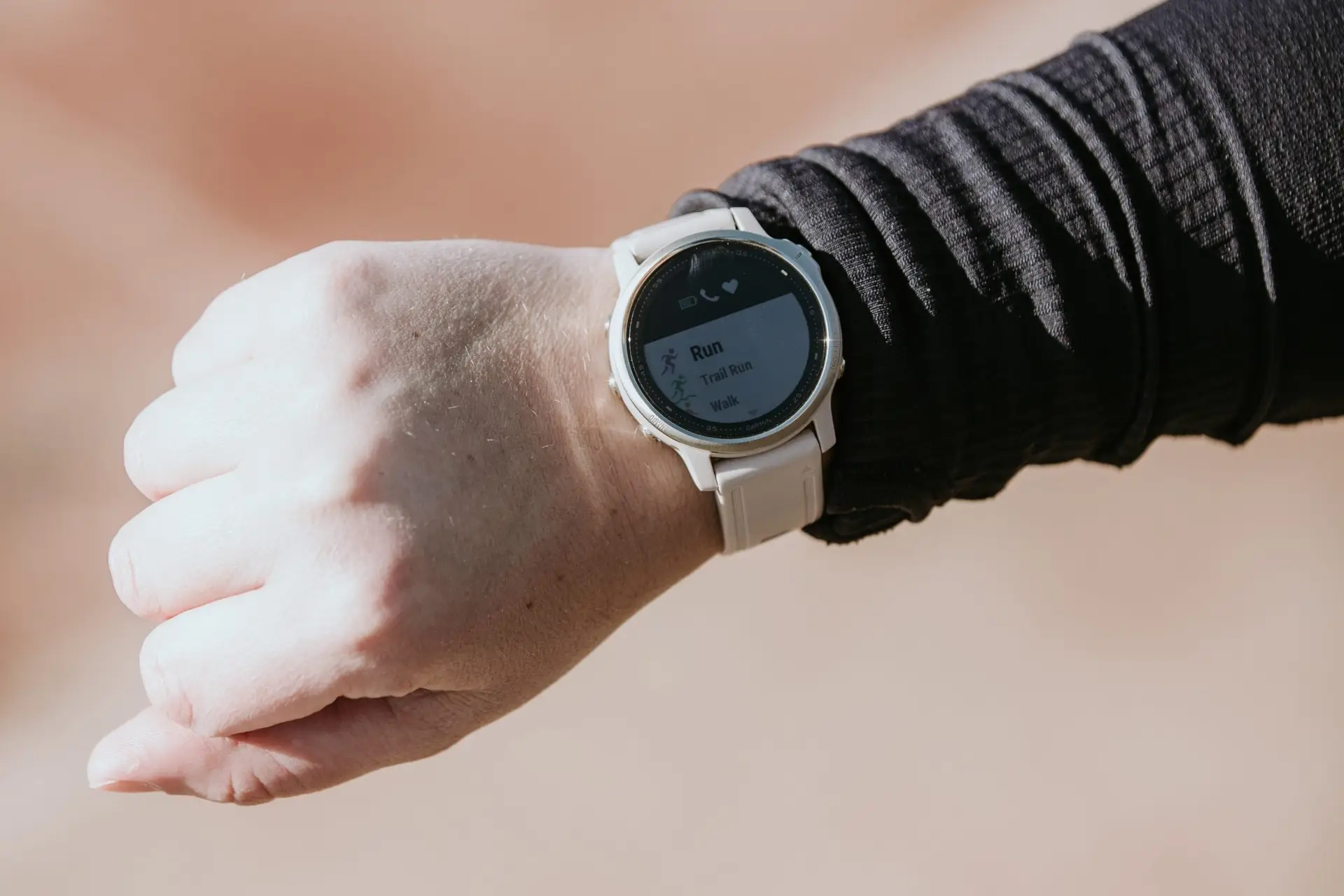 A closeup image of a Garmin watch to be used for heart rate training for a runner