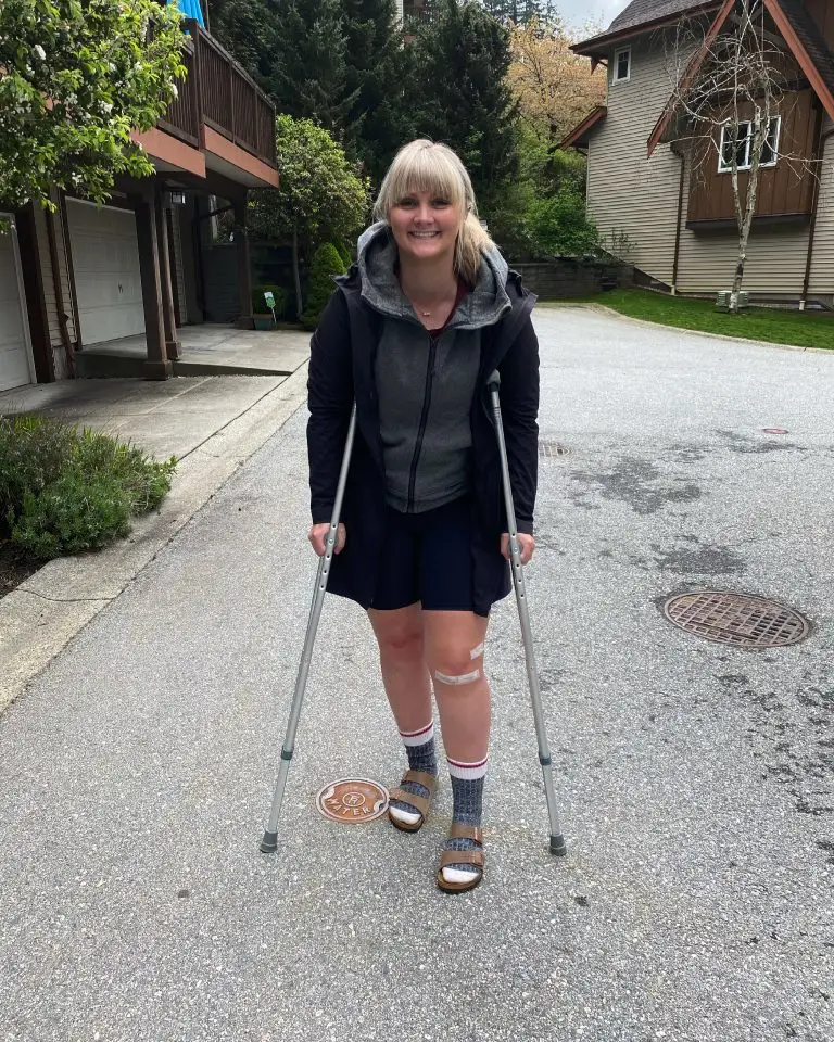 A runner using crutches after undergoing knee surgery